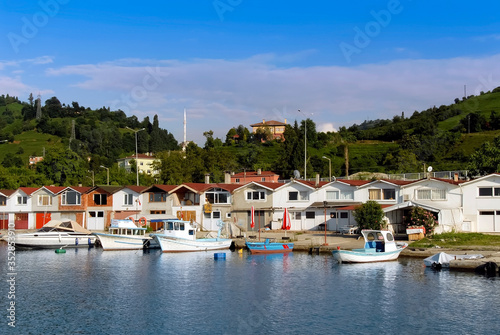 TRABZON, TURKEY - JULY 06, 2012: Fishing Shelter, Boats, Green hills and Buildings. Of District
