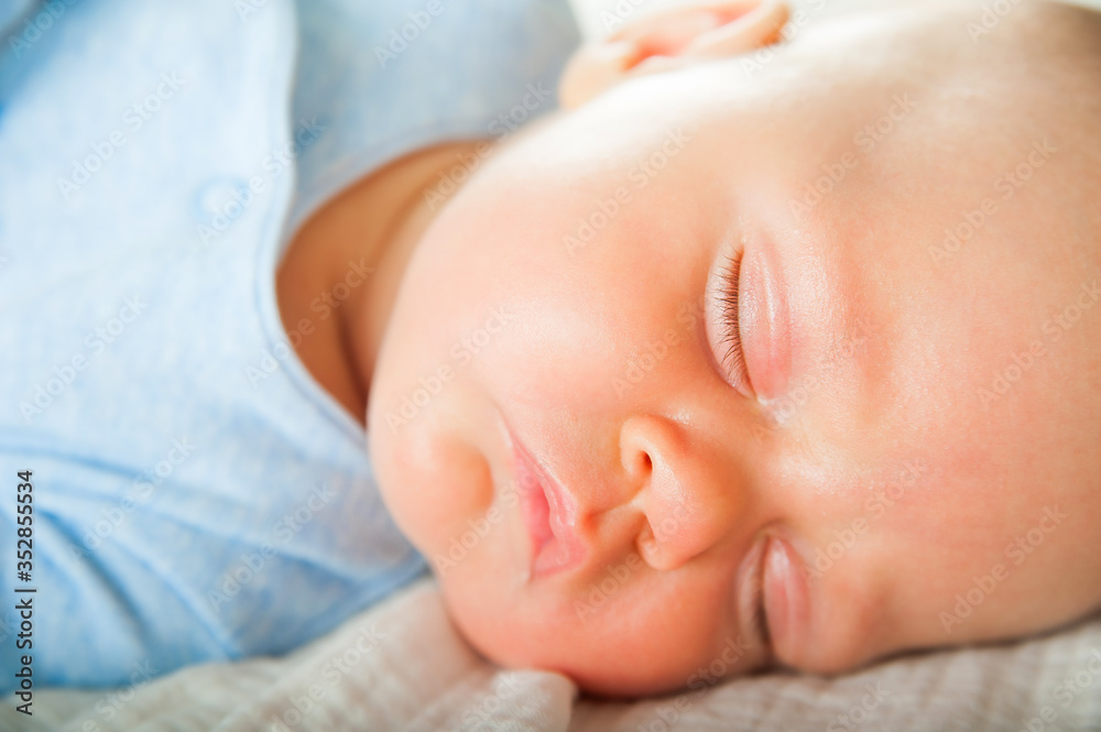 Newborn sleeping close up. Baby is sleeping soundly on the bed and copy space. Infant care, colic, sleep after bath. Newborn sleeping close up. Baby is sleeping soundly on the bed and copy space. Infant care, colic, sleep after bath.
