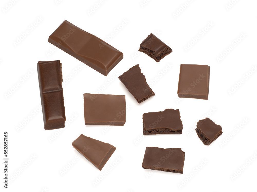 close up of dark porous chocolate and milk chocolate pieces on a white background