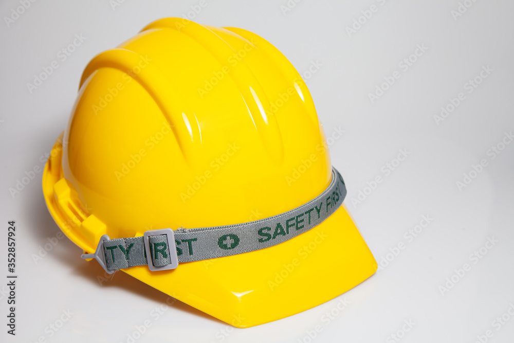 Fototapeta premium Yellow safety helmet on white background. Hard Hat or safety engineer helmet for construction site
