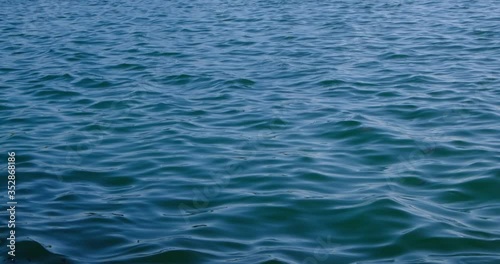 Calm blue ocean surface with gentle waves in summer. Relaxing and peaceful.
