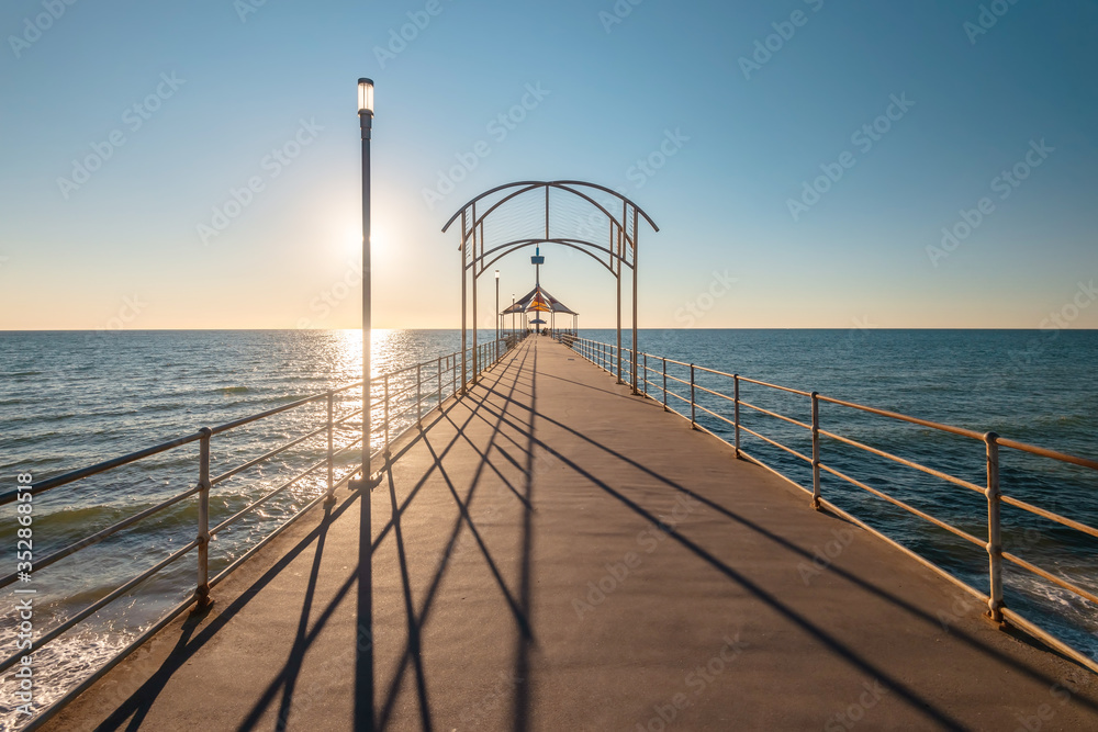 Iconic Brighton Jetty at sunset time with blue sky, South Australia