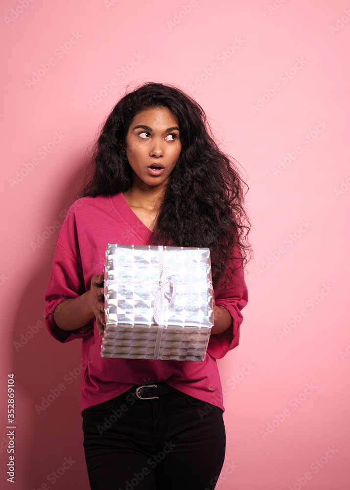 Surprised African woman with a gift in hands. Surprised African woman with a gift in hands.