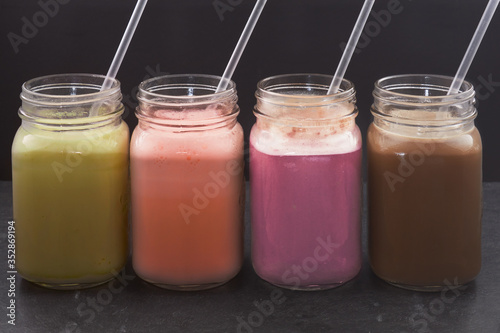 different flavors of whey protein shake - banna strawberry black