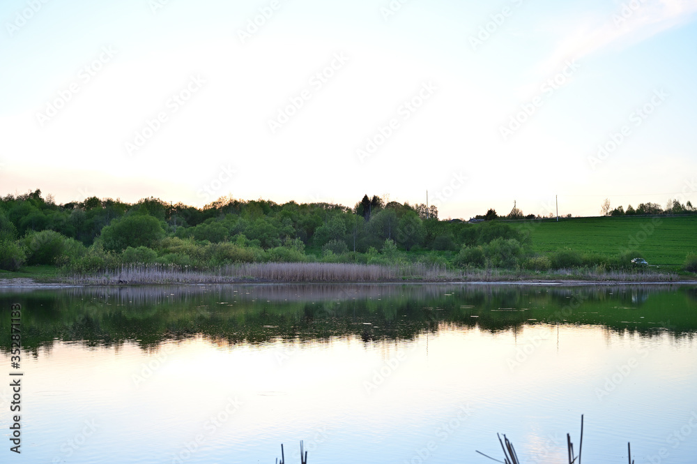Photo of a lake in a sunny sunset. The concept of heavenly tranquility. Photo of a lake in a sunny sunset. The concept of heavenly tranquility.