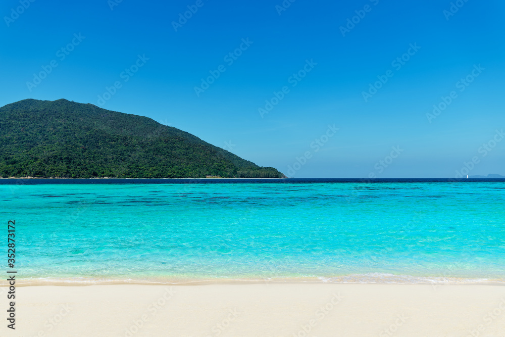 Turquoise clear sea and white sand beach on tropical island