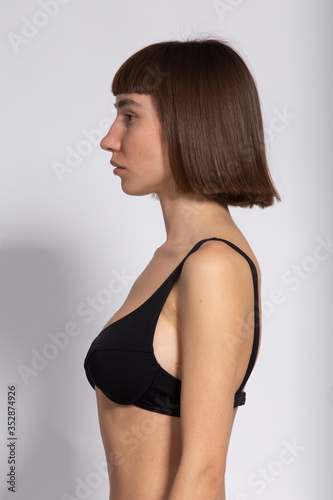pretty girl portrait in profile with dark short hairstyle