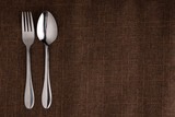 empty plate spoon fork and knife on table. Table setting on wooden table.setting with plate, fork, and spoon on wooden background