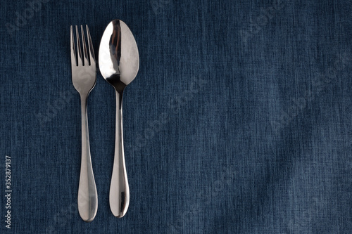 empty plate spoon fork and knife on table. Table setting on wooden table.setting with plate, fork, and spoon on wooden background