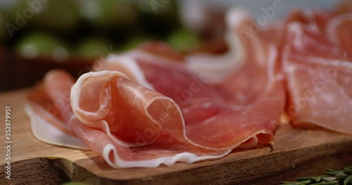 Antipasto of meat on the cutting Board rotates slowly.