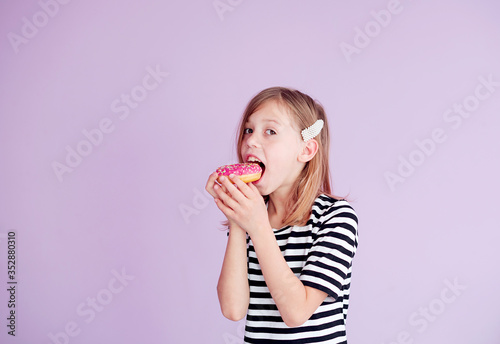 young woman eating donut.