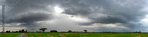 Fototapeta Panorama Super storm with sun light , Dark sky and dramatic black cloud before rain