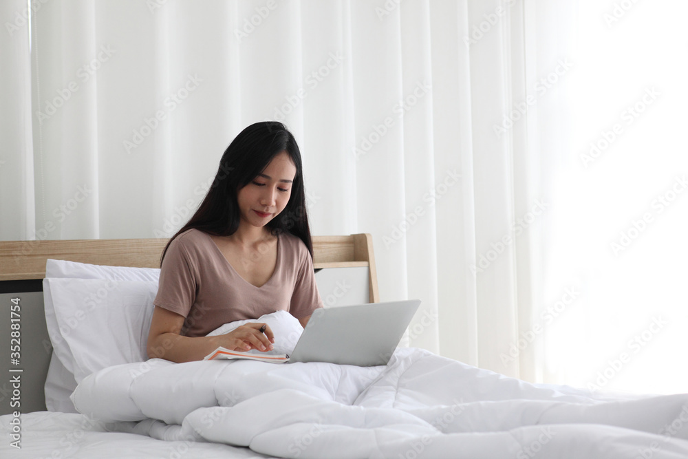 woman using laptop on bedroom , work from home. Technology and communication woman using laptop on bedroom , work from home. Technology and communication