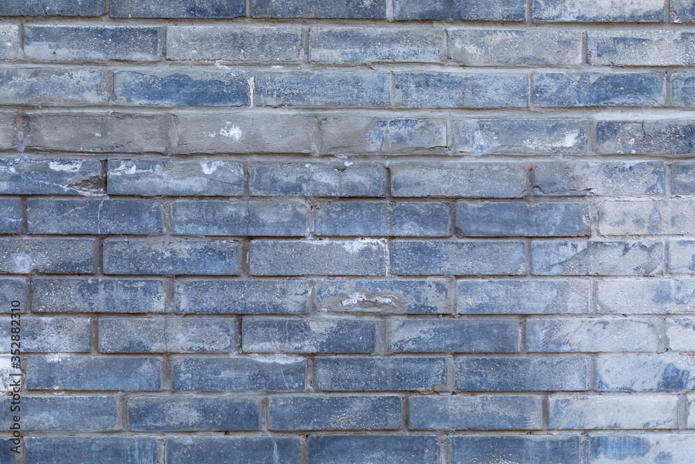 The background of a multicolor gradient painted brick wall of uneven fascia. Difference of color. Blue and brown shade of paint The background of a multicolor gradient painted brick wall of uneven fascia. Difference of color. Blue and brown shade of paint
