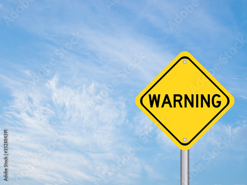 Quadro su tela Yellow color transportation sign with word warning on blue cloud sky background