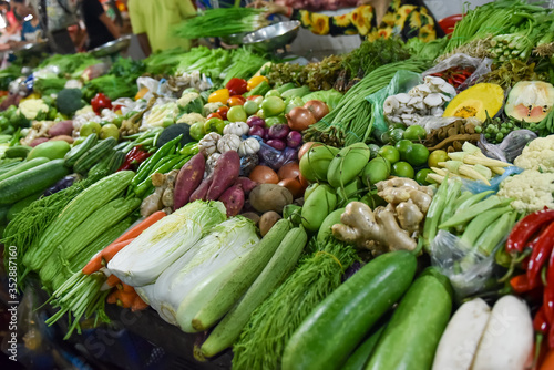 many types of vegetables are on the counter in the asian market