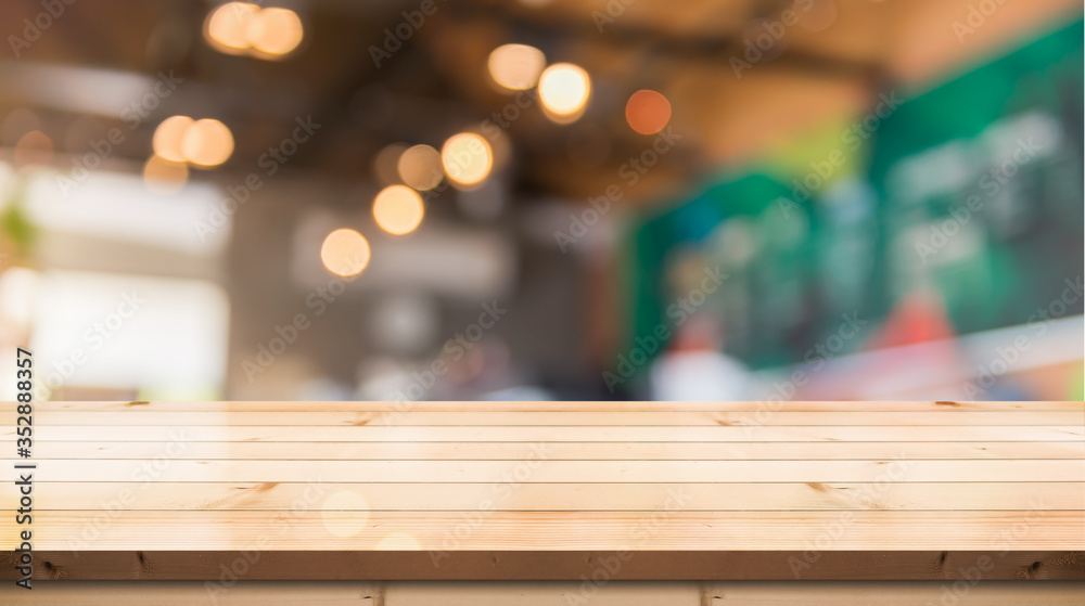 Empty wooden table top with lights bokeh on blur restaurant background Empty wooden table top with lights bokeh on blur restaurant background