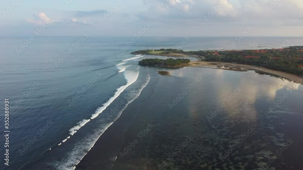 Aerial view evening beach Bali with waves and clouds Aerial view evening beach Bali with waves and clouds