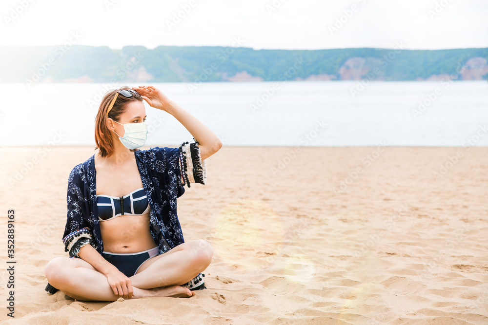 Beautiful European girl on an empty beach in a bikini and a light summer Cape Beautiful European girl on an empty beach in a bikini and a light summer Cape