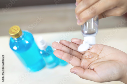 woman using bottle of antibacterial sanitizer soap. alcohol gel dispenser rub cleaning hand hygiene prevention of corona virus. outbreak. antiseptic the spread of germ and bacteria infection covid 19.