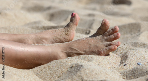 Close-up of a girl's leg on the beach.