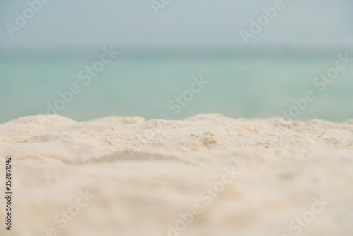 Blurred and soft focus sandy beach blue ocean and sky