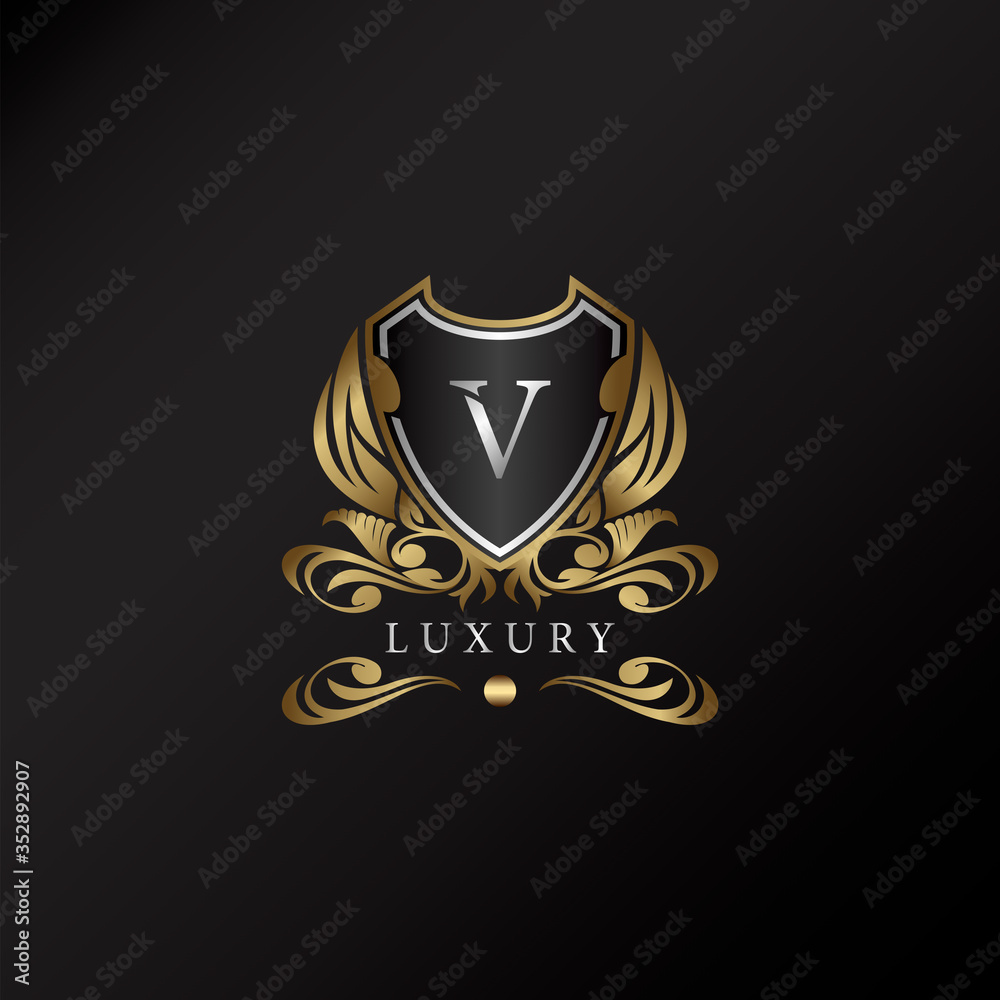 Shield logo in gold color with letter V Logo. Elegant logo vector template made of wide silver alphabet font on shield frame ornate style.
