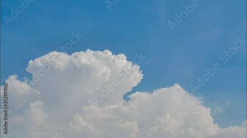 Time lapse white clouds in blue sky.