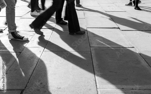 Shadow of People walking in crowded street. Black and White photo of shadow of people. Pedestrian in a street. Blur Shadows of people walking in a street of the city.