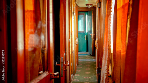 Interior of long hallway in old retro wooden train car photo