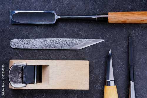 Collection of Japanese carpentry tools on a stone surface. Woodworking, craftsmanship concept, flat lay