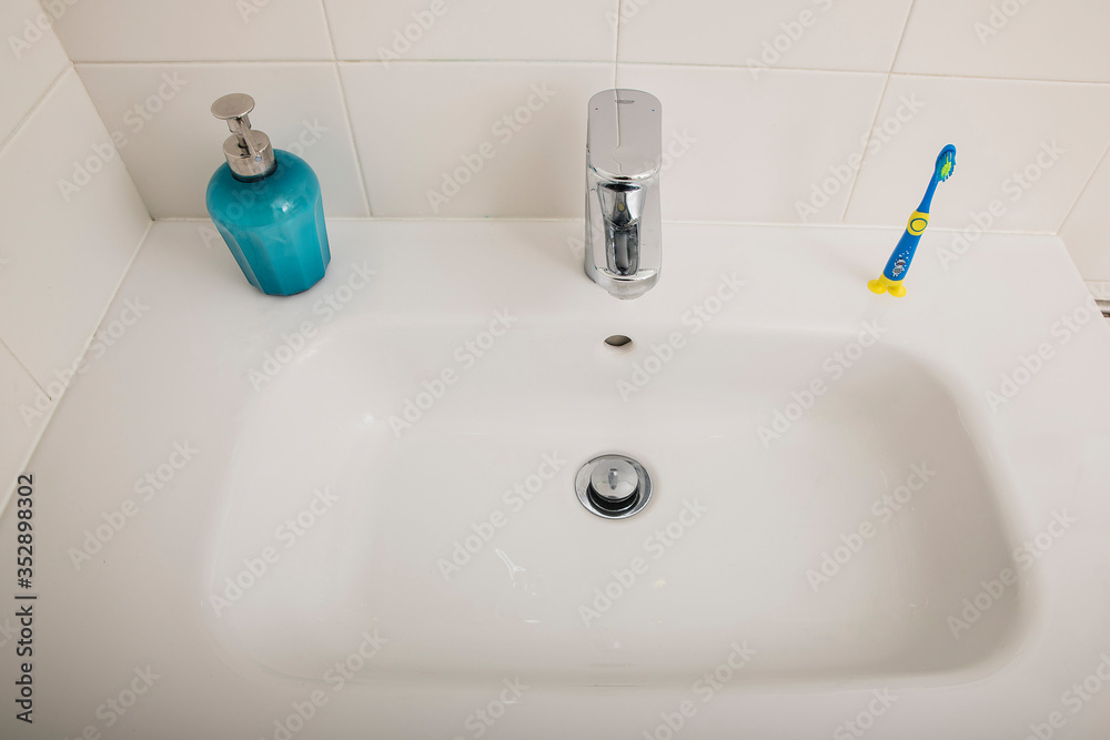 Interior of bathroom with sink basin faucet and blue soap. Design of bathroom
Interior of bathroom with sink basin faucet and blue soap. Design of bathroom