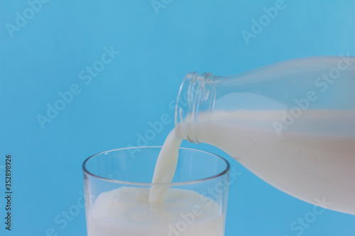 Natural cow's village milk is poured into a glass.