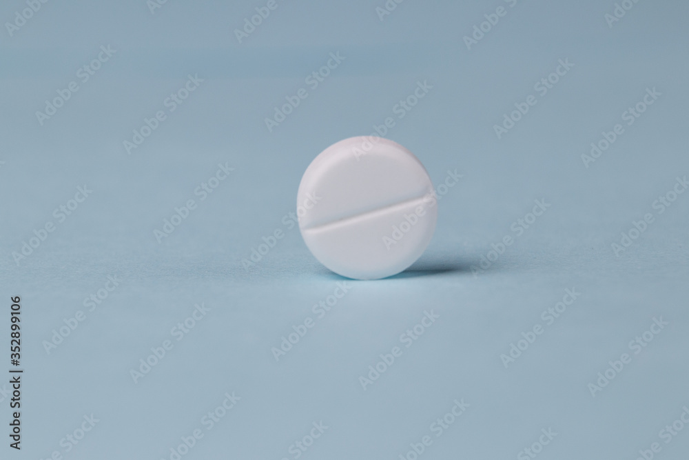 pills background, tablets on a blue background pills background, tablets on a blue background