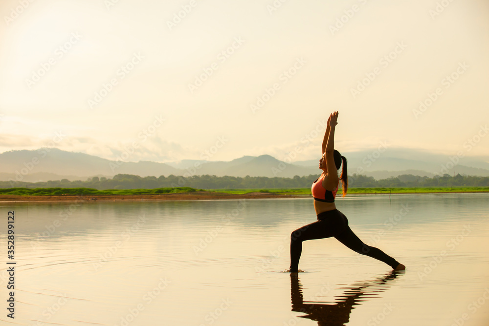 Relax asian woman standing doing yoga with nature background Relax asian woman standing doing yoga with nature background