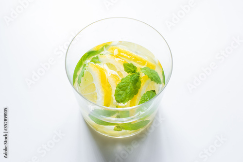 fresh lemonade in glass with mint on white background