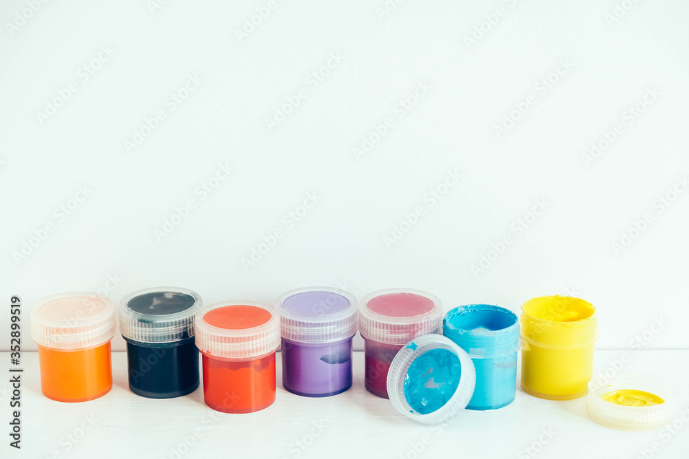 Colorful gouache paints on white wooden table. Copy, empty space for text Colorful gouache paints on white wooden table. Copy, empty space for text