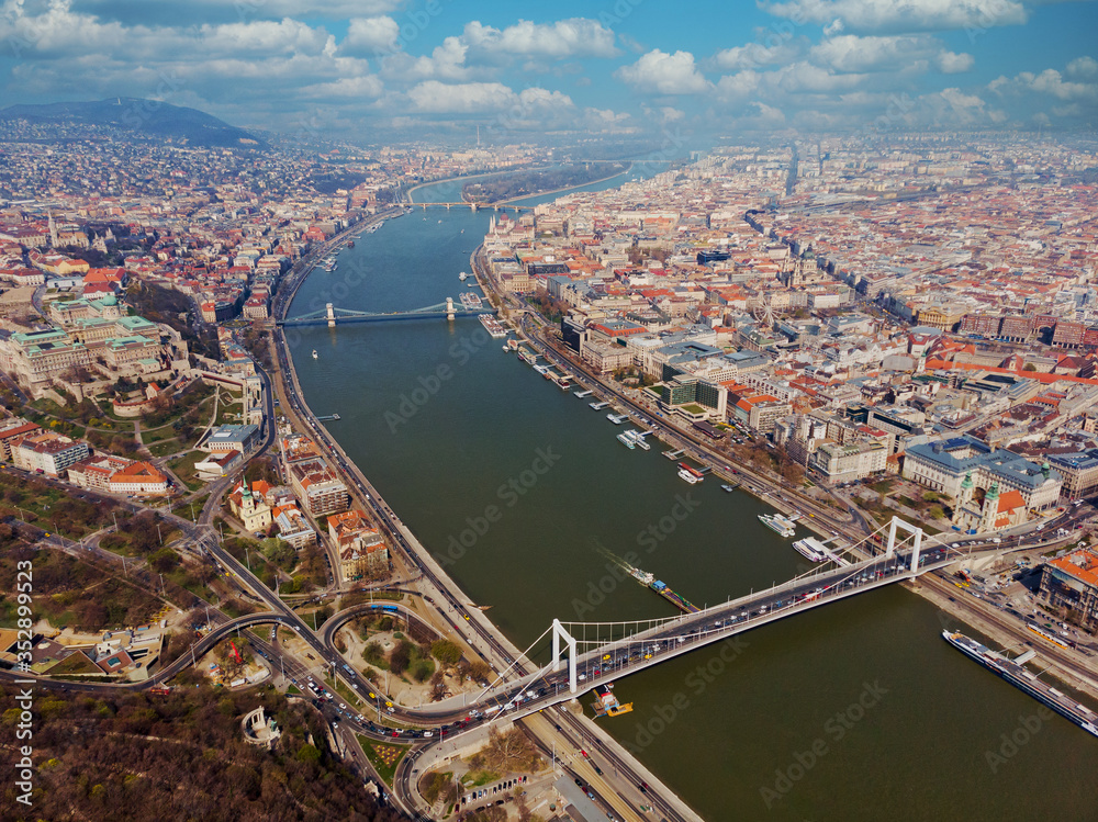 Beautiful morning flight over Budapest. Top view of the royal palace of the Habsburgs, Danube, Szechenyi Chain Bridge, beautiful clouds. Hungary.