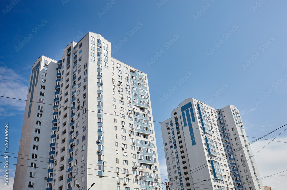 Modern East European residential apartment buildings quarter on a sunny day with a blue sky.Abstract architecture, fragment of modern urban geometry
