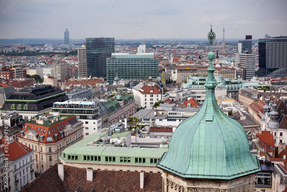 Vienna in Austria, capital city cityscape with rooftop of St. Stephen Cathedral. View on Dome of St. Peter's Church Peterskirche. 18th century Baroque style architecture