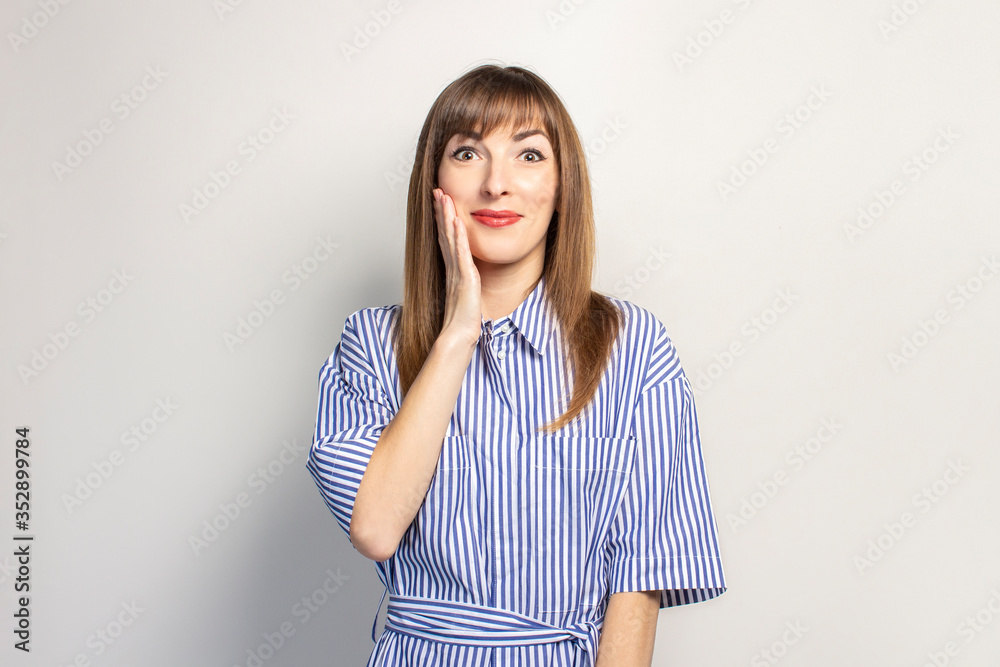 surprised young girl on a light background. Concept is win, sale, discount, gift. Banner surprised young girl on a light background. Concept is win, sale, discount, gift. Banner