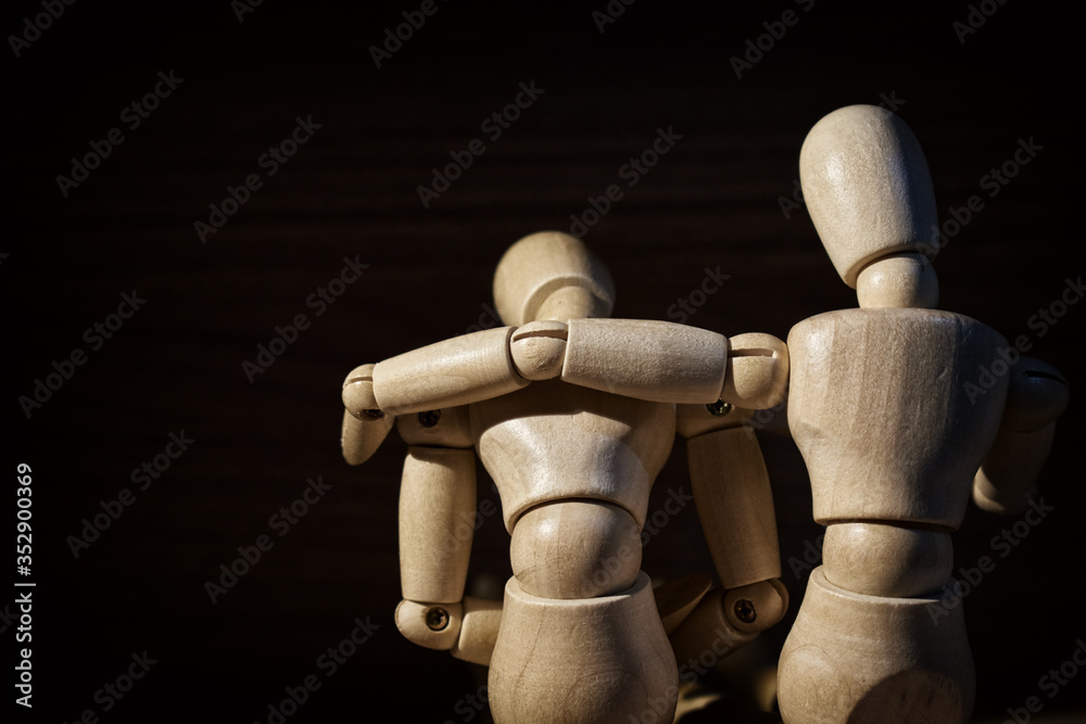 Wooden mannequin, Concern and worry of friend. Mental health, PTSD and suicide prevention. Post-traumatic stress disorder. Wooden mannequin, Concern and worry of friend. Mental health, PTSD and suicide prevention. Post-traumatic stress disorder.