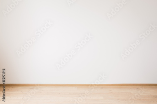 grey empty wall and wooden beige floor photo