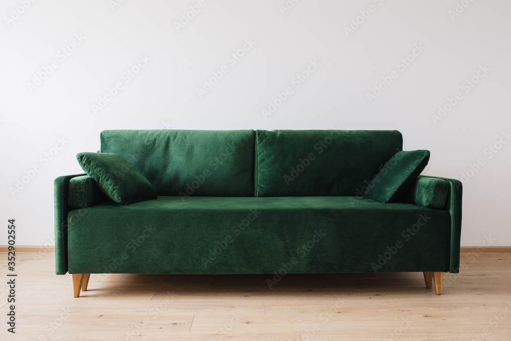 modern green sofa with pillows in room modern green sofa with pillows in room