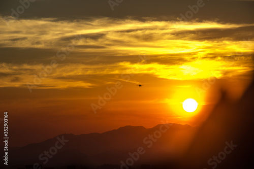 silhouette of a plane with a beautiful sunset seen from the city of Niteroi park.