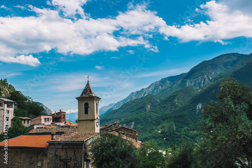 A picturesque wide landscape view of a French medieval village in the valley of Var river in the Alps on a sunny day (Touët-sur-Var, Alpes-Maritimes, France)