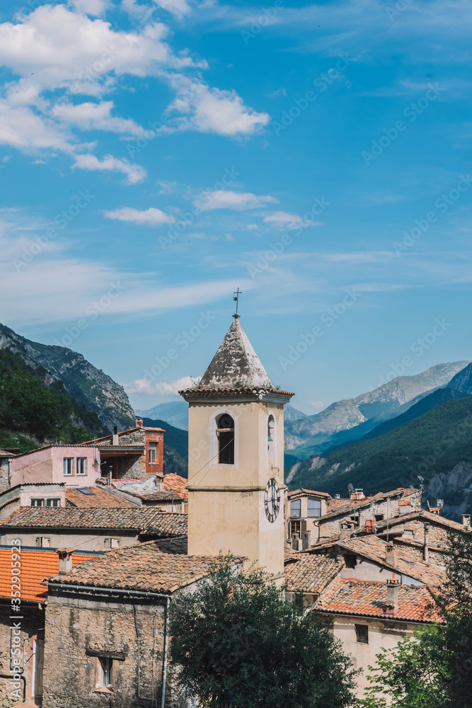 A picturesque view of a church tower bell in a French medieval village in the valley of Var river in the Alps on a sunny day (Touët-sur-Var, Alpes-Maritimes, France)