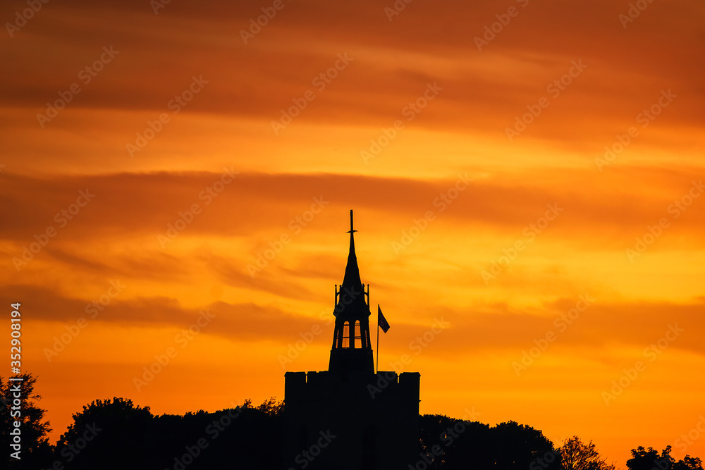 Orange colour sunset sky over Boxford church tower, Suffolk, England, Europe