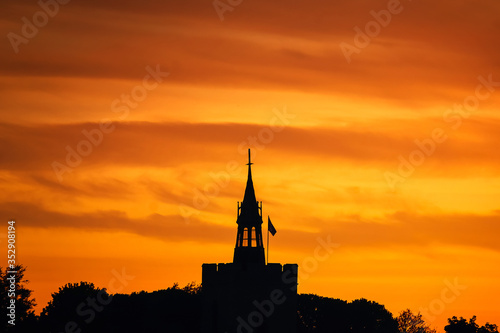 Orange colour sunset sky over Boxford church tower, Suffolk, England, Europe