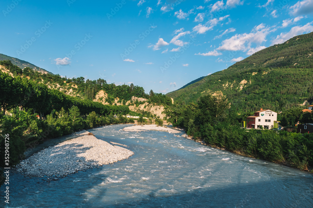 A picturesque landscape view of the valley of Var river in the Alps mountains on a sunny day (Puget-Theniers, Alpes-Maritimes, France) A picturesque landscape view of the valley of Var river in the Alps mountains on a sunny day (Puget-Theniers, Alpes-Maritimes, France)